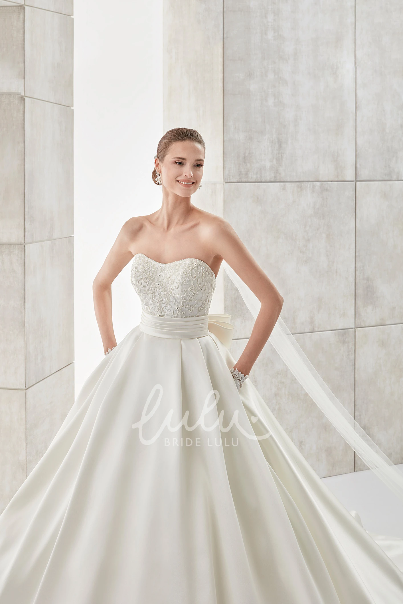 A-line Wedding Dress with Strapless Neckline Cinched Waistband and Back Bow