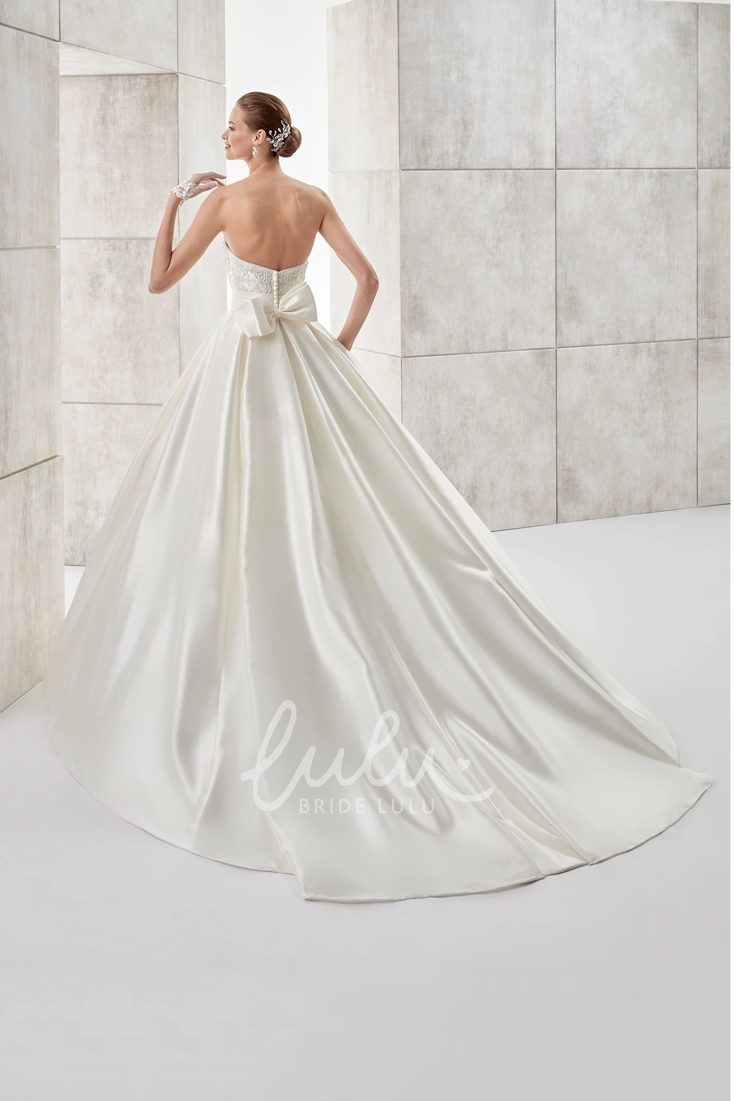 A-line Wedding Dress with Strapless Neckline Cinched Waistband and Back Bow
